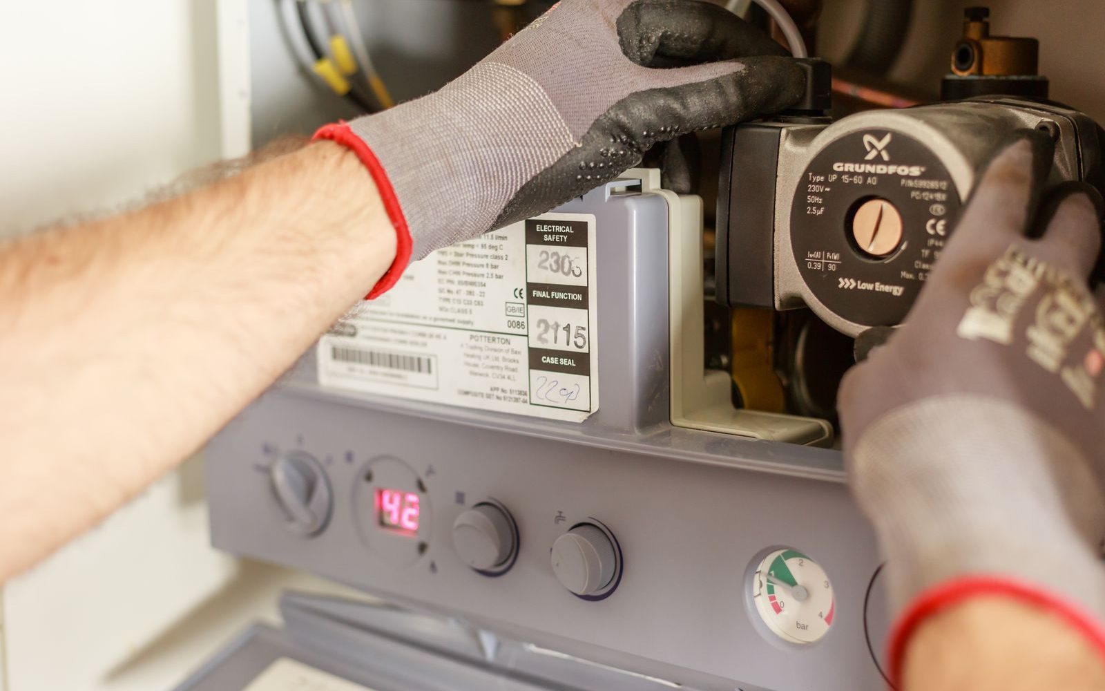 Plumber servicing a heating system pump